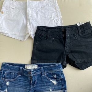 Three pairs of short shorts: white, denim, black